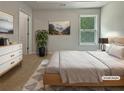Staged bedroom with neutral walls, carpet, and a picture window offering natural light at 3517 Mortons Landing Dr, Ellenwood, GA 30294