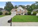 Inviting home showcasing a stone and stucco exterior, tidy lawn, and an attached two-car garage at 4360 Canterbury Walk Dr, Duluth, GA 30097