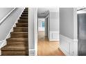 Inviting hallway features hardwood floors, neutral paint, and staircase to the upper level at 1417 Poplar Pointe Se, Smyrna, GA 30082