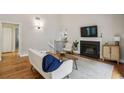 Bright living room with hardwood floors, fireplace, and comfortable seating area at 85 Dunwoody Springs Dr, Sandy Springs, GA 30328
