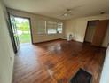 Spacious living room with hardwood floors, natural light, and classic ceiling fan at 6380 Mableton Sw Pkwy, Mableton, GA 30126