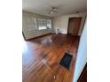 Bright living room featuring hardwood floors, a classic ceiling fan, and natural light at 6380 Mableton Sw Pkwy, Mableton, GA 30126