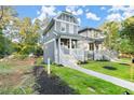 Attractive gray home with covered porch, set on a green lawn and charming curb appeal at 1697 Thomas St, Decatur, GA 30032