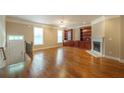 Elegant living room featuring hardwood floors, built-in bookshelves, and a charming fireplace at 2264 Ewell Park Dr, Lawrenceville, GA 30043