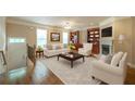 Inviting living room with hardwood floors, a cozy fireplace, built-in bookshelves, and abundant natural light at 2264 Ewell Park Dr, Lawrenceville, GA 30043