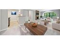 Open concept living room and dining room with stone fireplace and access to a balcony at 23307 Plantation Ne Dr, Atlanta, GA 30324