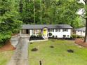 View of the attractive home showing the landscaping, brickwork, and an inviting yellow front door at 4396 Greenleaf Cir, Atlanta, GA 30331