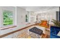 Sunlit living room featuring hardwood floors, built-in cabinets, and stylish decor at 2900 Townley Cir, Atlanta, GA 30340