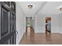 Elegant foyer with hardwood floors, white wainscoting, and a view into other rooms at 535 Watercress Dr, Woodstock, GA 30188