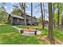 Serene backyard featuring a fire pit with built-in benches, perfect for outdoor entertaining and relaxation at 5759 Albans Way, Lithonia, GA 30058