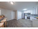 Eat-in kitchen featuring stainless steel appliances, modern white cabinets, and a gray backsplash at 5779 Wellborn Creek Dr, Lithonia, GA 30058