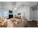 Bright living room with fireplace, ceiling fan, and doorway to a bedroom at 5779 Wellborn Creek Dr, Lithonia, GA 30058