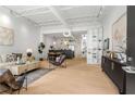 Bright, open-concept living room featuring hardwood floors, modern decor, and seamless flow to the kitchen and dining area at 820 Dekalb Ne Ave # 2, Atlanta, GA 30307