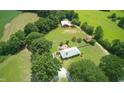 Expansive property featuring a home, a guest house, and a large, well-maintained yard surrounded by trees at , Social Circle, GA 30025