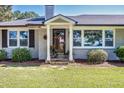 Close-up of the home's entrance, showcasing a charming porch, updated windows, and manicured landscaping at , Social Circle, GA 30025