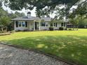Charming single-story home with a well-maintained lawn, a stone walkway, and meticulously trimmed hedges at , Social Circle, GA 30025