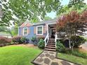 View of blue house with front yard and stone walkway to the porch with outdoor seating at 3226 Hope St, Hapeville, GA 30354