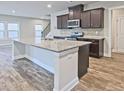 Kitchen featuring granite countertops, stainless steel appliances and large island with sink at 3305 Morgan Rd, Buford, GA 30519