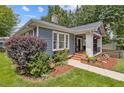 Charming blue home with manicured lawn, lush greenery, and inviting entrance at 588 Angier Ne Ave, Atlanta, GA 30308
