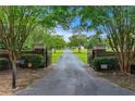 An impressive gated entrance and a long driveway lead up to this sprawling estate property at 2595 Ross Rd, Snellville, GA 30039