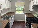 Functional kitchen with white cabinets, stainless steel appliances, and laminate countertops at 3951 Mcgill Dr, Decatur, GA 30034