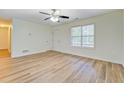 Bright room features wood-look floors, a ceiling fan, and a window at 4547 Atha Cir, Loganville, GA 30052