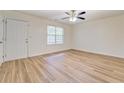 Well-lit bedroom features stylish wood-look floors and a ceiling fan at 4547 Atha Cir, Loganville, GA 30052