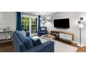 Cozy living room features stylish furniture, hardwood floors, and French doors leading to a balcony at 1150 Collier Nw Rd # L14, Atlanta, GA 30318