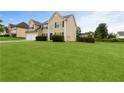 Well-maintained home featuring lush green lawn and mature landscaping on an expansive lot at 165 Heaton Place Trl, Covington, GA 30016