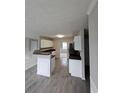 Kitchen with breakfast bar, white cabinets, granite countertops, and tiled floors at 165 Heaton Place Trl, Covington, GA 30016