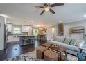 Open-concept living room featuring a modern kitchen, cozy seating, and stylish décor, perfect for relaxation and entertaining at 205 Plantation Sw Rd, Smyrna, GA 30082
