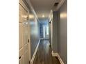 Hallway featuring gray walls, white trim, and wood-look floors at 1462 Knights Trl, Stone Mountain, GA 30083