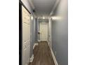Hallway featuring gray walls, white trim, and wood-look floors at 1462 Knights Trl, Stone Mountain, GA 30083