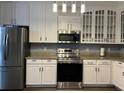 Bright kitchen with stainless steel appliances and white cabinetry at 1462 Knights Trl, Stone Mountain, GA 30083