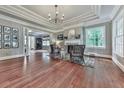 Elegant living room featuring hardwood floors, tray ceiling, fireplace and large windows offering natural light at 646 Darlington Ne Cir, Atlanta, GA 30305