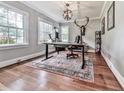 Home office with hardwood floors, natural light, and decorative light fixture and unique wall decorations at 646 Darlington Ne Cir, Atlanta, GA 30305