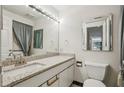 Bathroom features a light granite countertop, large vanity mirror, and tiled floors at 1130 Piedmont Ne Ave # 402, Atlanta, GA 30309