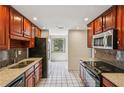 Kitchen features dark wood cabinetry, stainless steel appliances, and a window with natural light at 1130 Piedmont Ne Ave # 402, Atlanta, GA 30309
