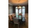 Charming dining room with a large table, stylish chairs, and beautiful natural light at 1450 Liberty Ln, Cumming, GA 30040