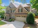Stunning two-story brick home featuring a lush green lawn and attached two-car garage at 1450 Liberty Ln, Cumming, GA 30040