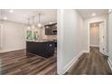 Modern kitchen features granite countertops, dark cabinetry, and stainless steel appliances at 1749 W Caribaea Se Trl, Atlanta, GA 30316