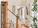 Bright foyer view with wood floors, staircase and welcome decor at 3574 Timberloch Trl, Snellville, GA 30039