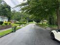 A quiet street featuring a mix of charming homes surrounded by mature trees and green lawns at 2351 Carver Nw Dr, Atlanta, GA 30314