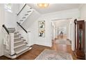 Bright foyer featuring a staircase, hardwood floors, and views into adjoining rooms at 54 Camden Ne Rd, Atlanta, GA 30309