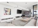 Elegant living room with modern fireplace, flat screen TV, and open layout leading to the dining area at 788 W Marietta St # 1809, Atlanta, GA 30318