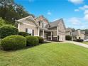 A charming two-story home with a well-manicured lawn and lush landscaping at 200 Pine Trl, Dallas, GA 30157