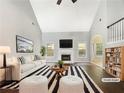 A bright living room featuring a fireplace and stylish decor. (Virtually Staged) at 200 Pine Trl, Dallas, GA 30157