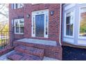 Inviting front entrance with brick steps and decorative sidelights at 2001 Towne Lake W Hls, Woodstock, GA 30189