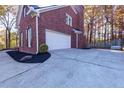 Attached garage with a paved driveway at 2001 Towne Lake W Hls, Woodstock, GA 30189