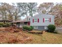 Charming split level home with red door, painted brick and a covered side entrance at 2475 Harvel Nw Dr, Atlanta, GA 30318